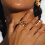 Nova star cocktail ring worn on hand in editorial portrait with matching statement earrings.