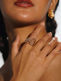 Nova star cocktail ring worn on hand in editorial portrait with matching statement earrings.