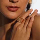 Nova zircon star ring worn on hand close-up in warm editorial light showing full sculptural detail.