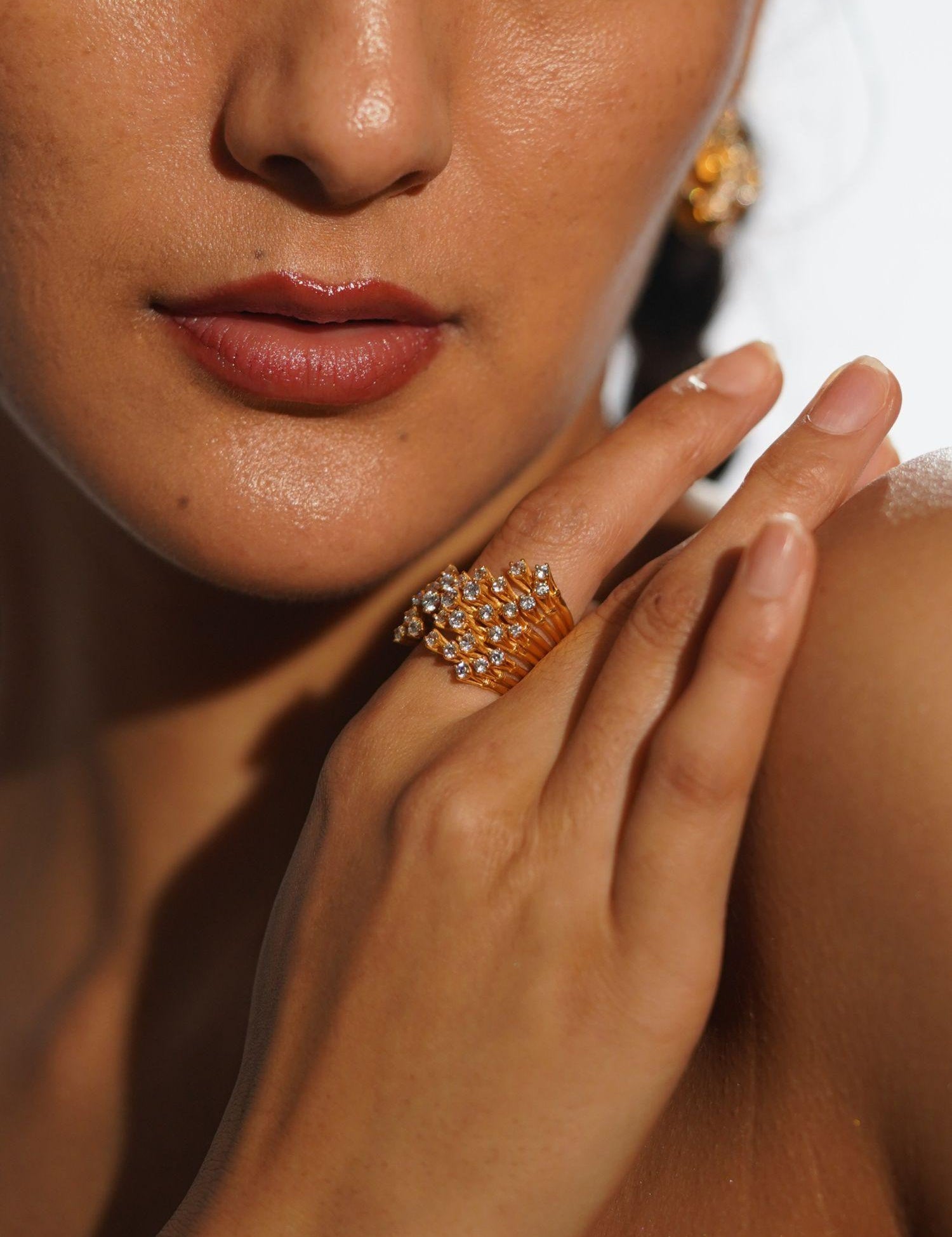 Nova zircon star ring worn on hand close-up in warm editorial light showing full sculptural detail.