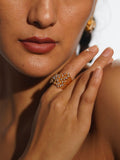 Nova zircon star ring worn on hand close-up in warm editorial light showing full sculptural detail.