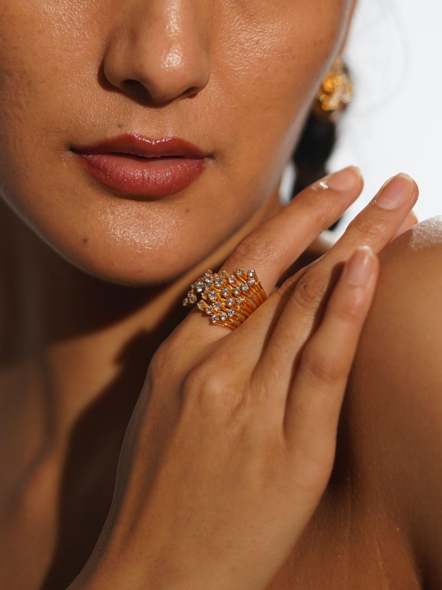 Nova zircon star ring worn on hand close-up in warm editorial light showing full sculptural detail.