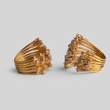 Two Nova rings side by side showing full sculptural star silhouette in gold on neutral background.
