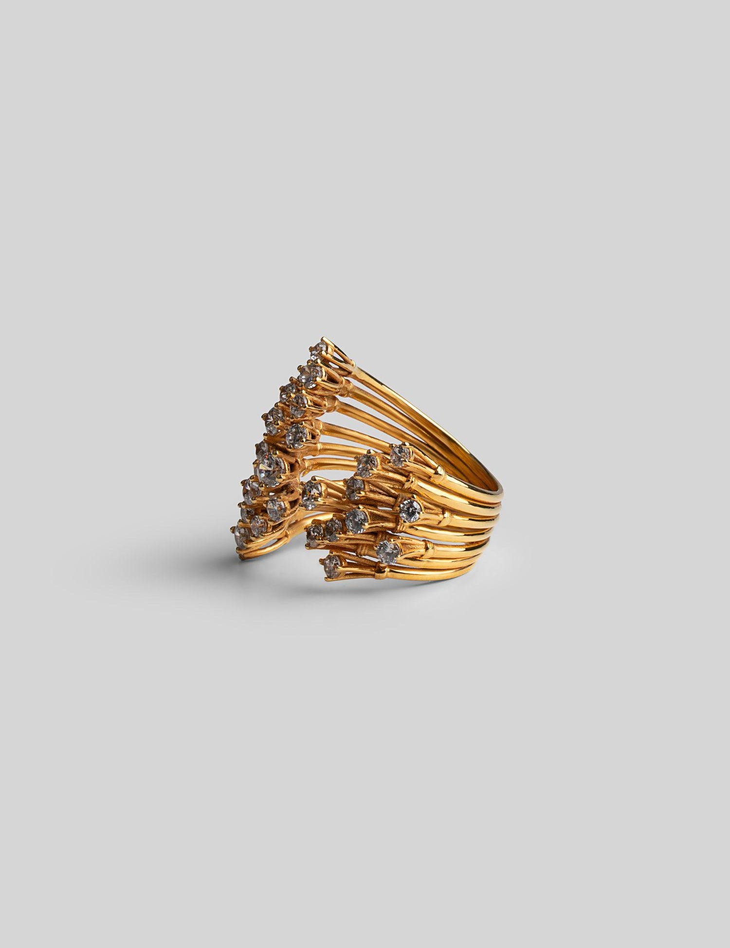 Pair of Nova star cocktail rings in 24k gold shown together at three-quarter angle on neutral background.