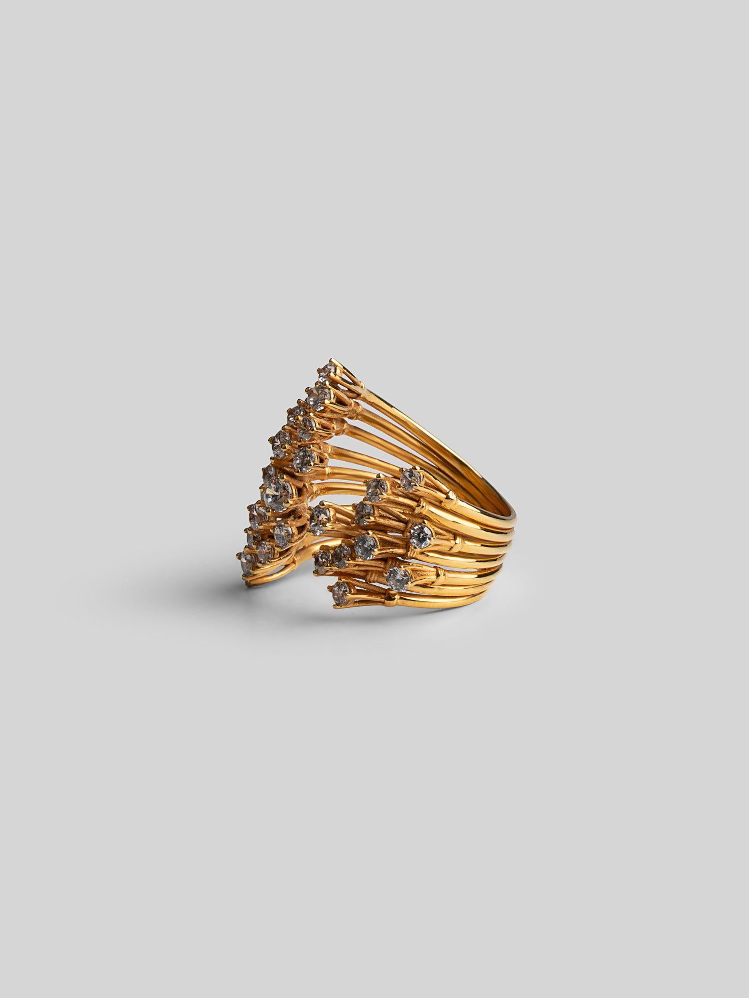 Pair of Nova star cocktail rings in 24k gold shown together at three-quarter angle on neutral background.