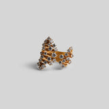 Side angle of Nova ring showing zircon-encrusted star form rising from a layered gold band.