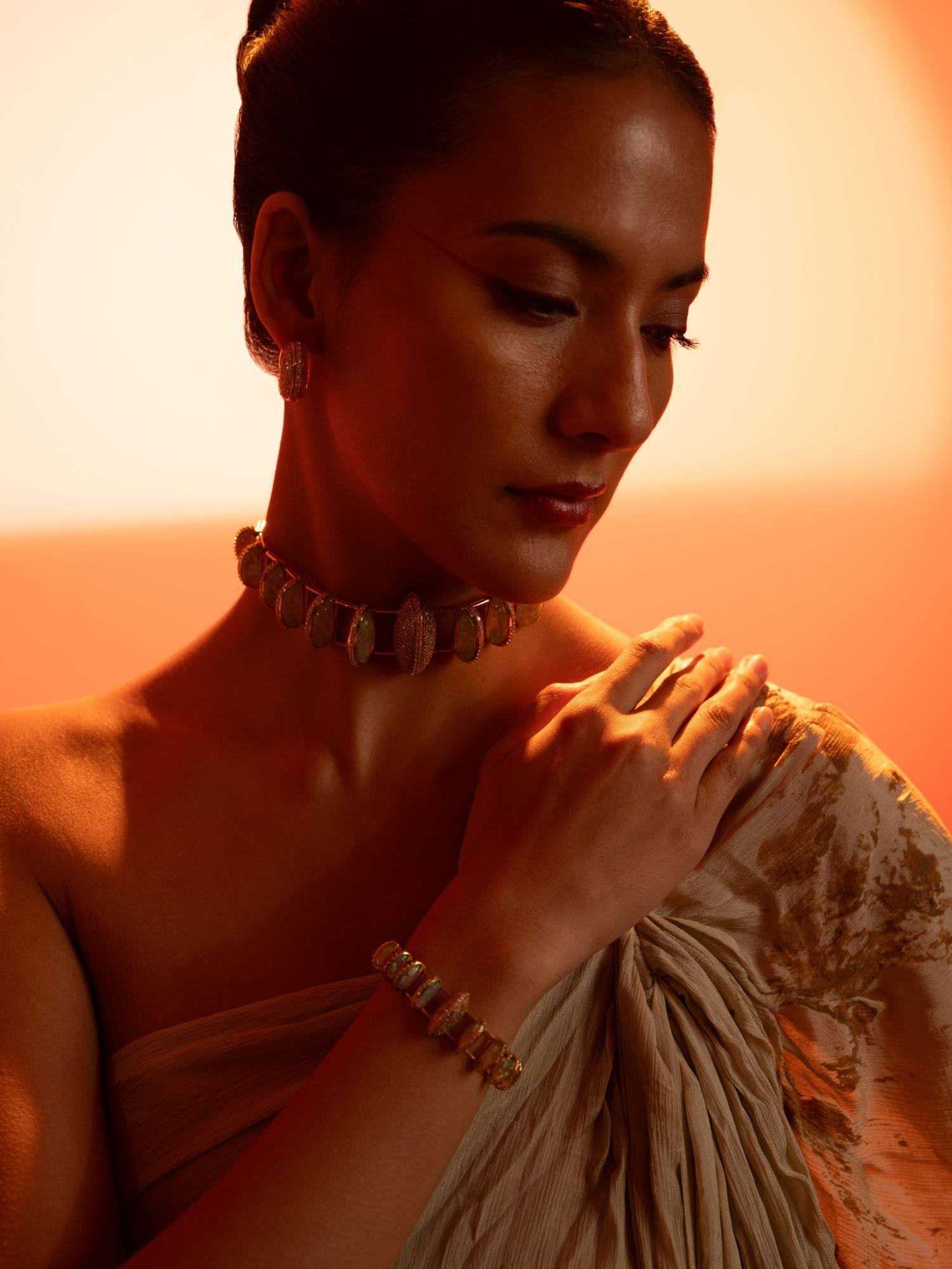 Model wearing Opal Perspective necklace and bracelet together in a golden-hour editorial portrait.