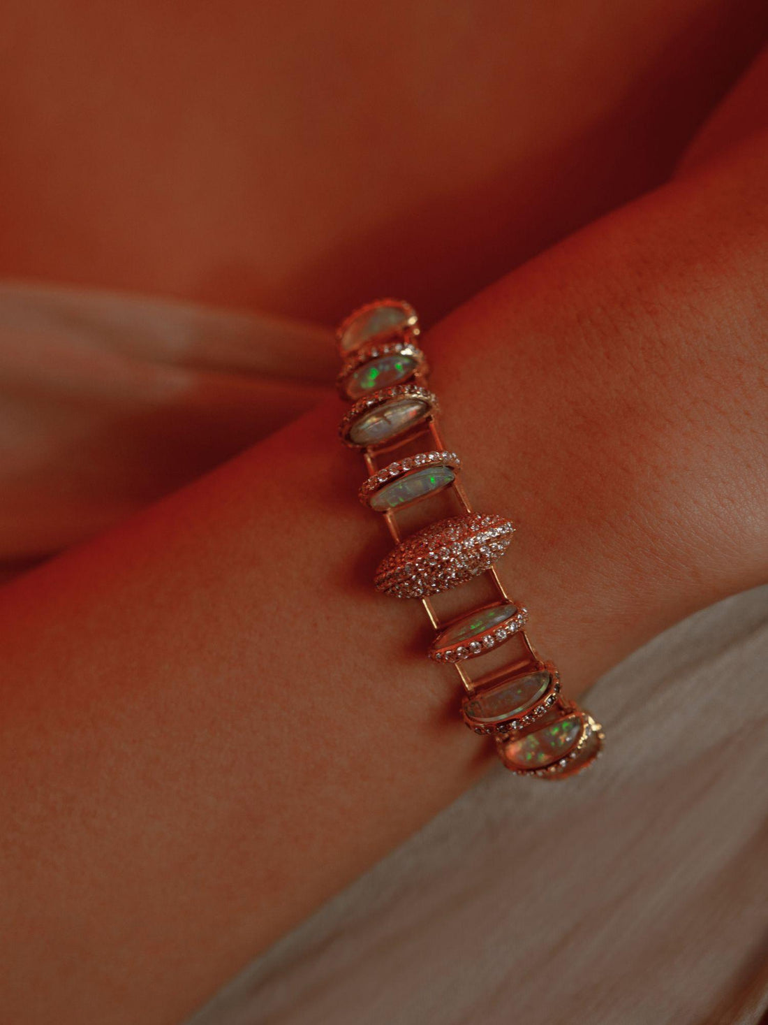 Opal Perspective bracelet with alternating opal crystal and zircon stones in 24k gold on neutral background.