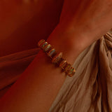 Opal Perspective designer bracelet with opal and zircon stones worn on wrist in warm light.
