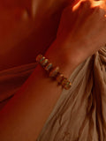 Opal Perspective designer bracelet with opal and zircon stones worn on wrist in warm light.