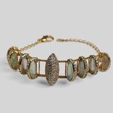 Opal Perspective bracelet with alternating opal crystal and zircon stones in 24k gold on neutral background.