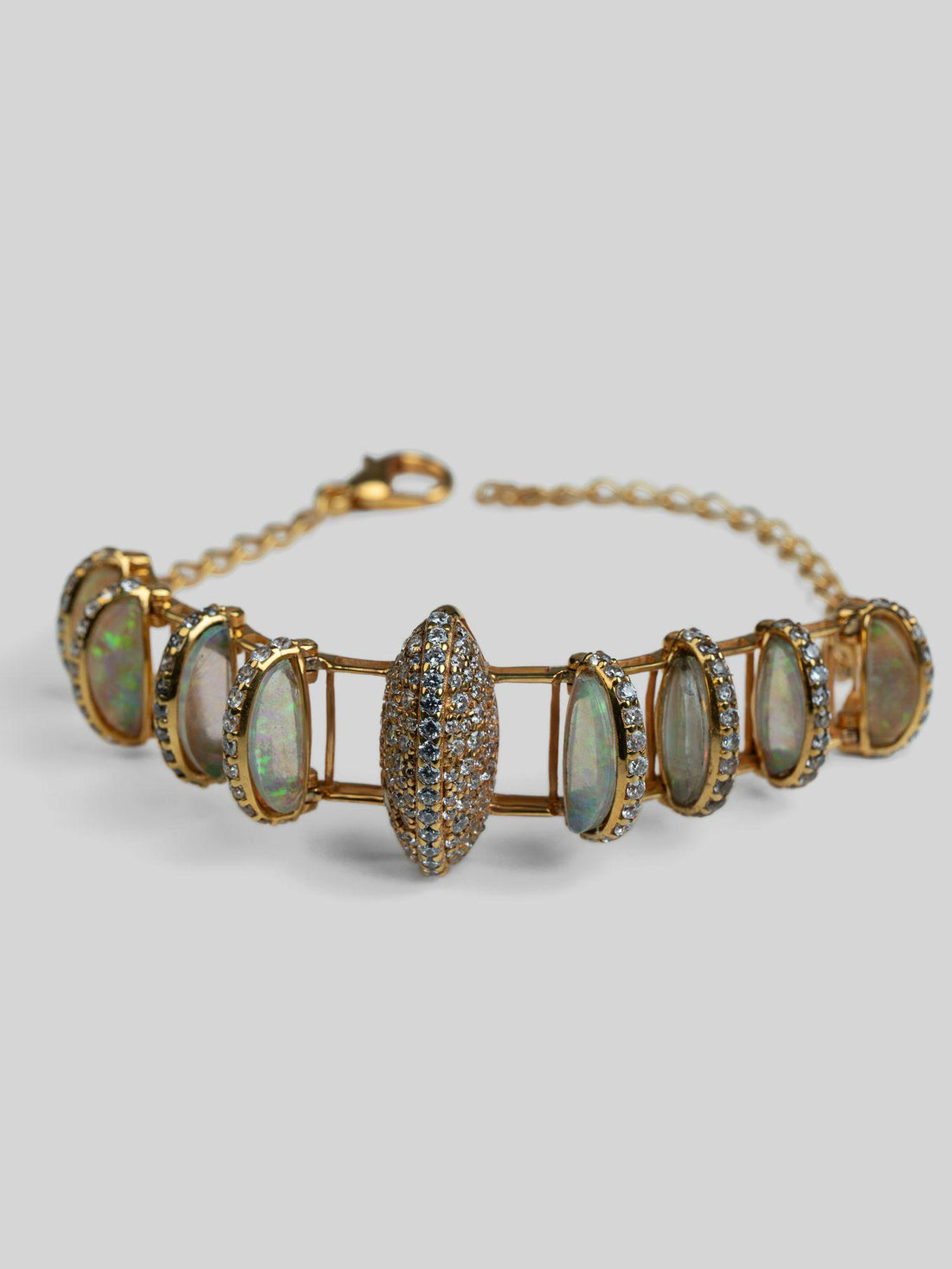 Opal Perspective designer bracelet with opal and zircon stones worn on wrist in warm light.
