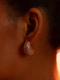 Opal Perspective reversible earrings worn front-facing in dramatic warm editorial lighting.