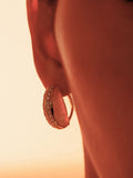 Close profile of Opal Perspective reversible statement earrings in 24k gold against warm skin.