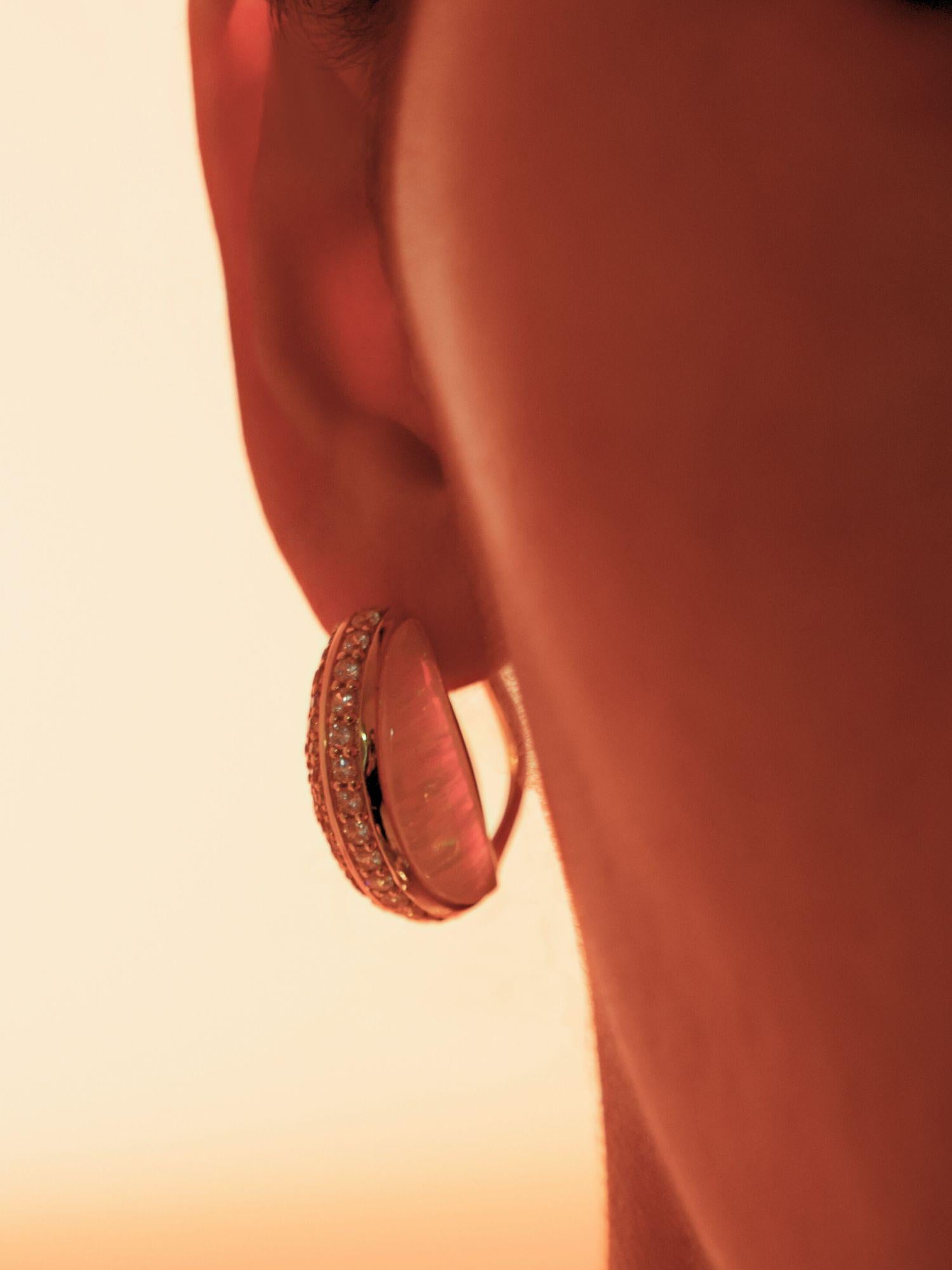 Close profile of Opal Perspective reversible statement earrings in 24k gold against warm skin.