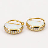 Close product shot of Opal Perspective earrings showing milky opal crystal haze face with zircon pavé edge.