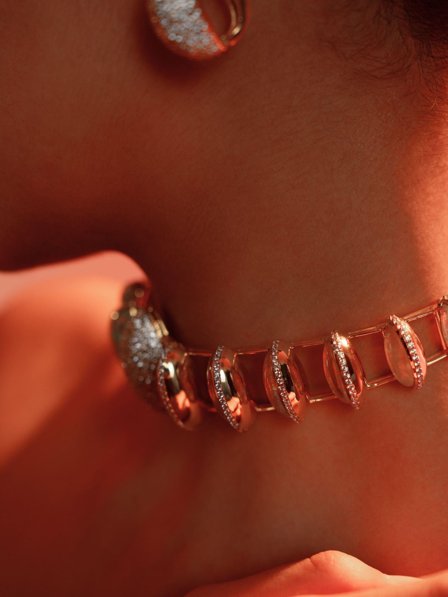 Opal crystal haze necklace worn close to the décolletage in a warm editorial close-up.