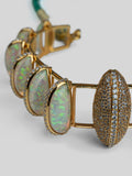 Close product shot of Opal Perspective necklace showing opal crystal haze and zircon detail in gold.