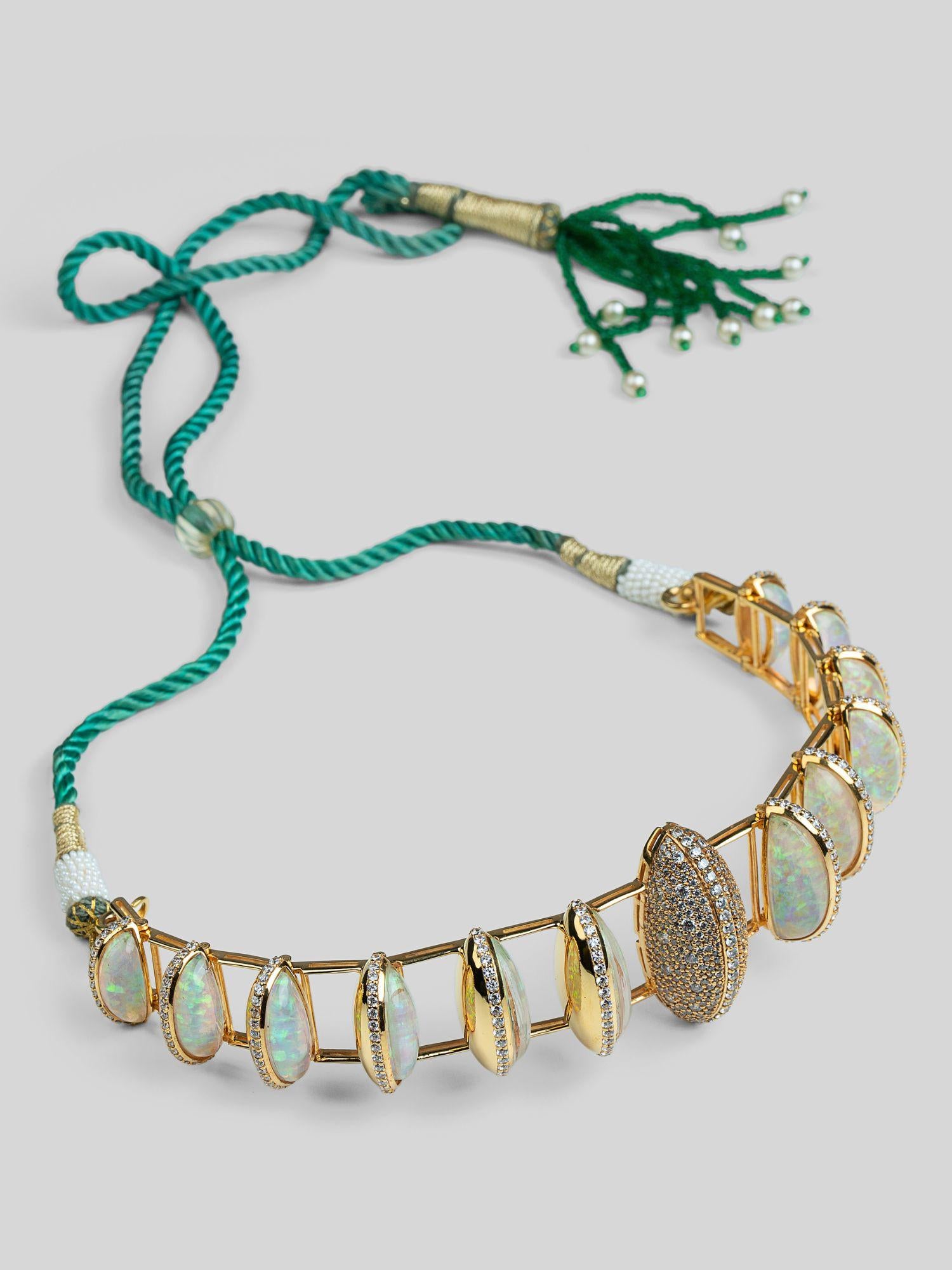 Opal Perspective necklace with opal crystal haze stones and green cord in 24k gold on neutral background.