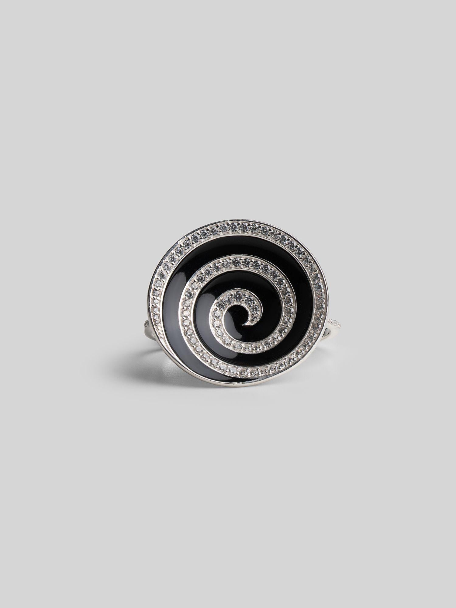 Orbis cocktail ring with spiral black enamel and zircon detail in white rhodium, front angle on neutral background.