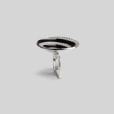  Front product shot of Orbis black enamel spiral ring in white rhodium on neutral background.