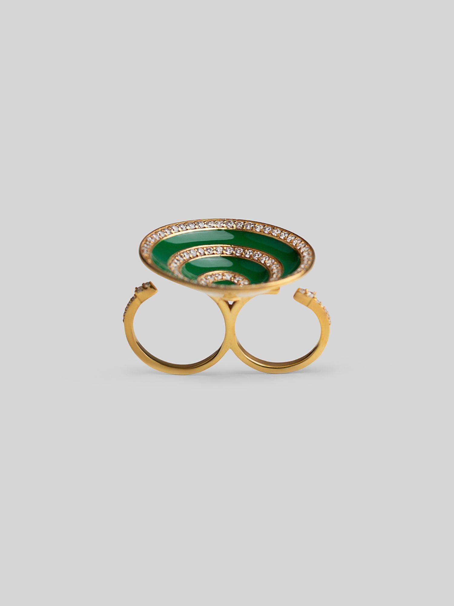 Orbis cocktail ring with spiral green enamel and zircon detail in 24k gold, front angle on neutral background.