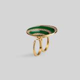  Three-quarter product shot of Orbis green enamel spiral ring in 24k gold on neutral background.