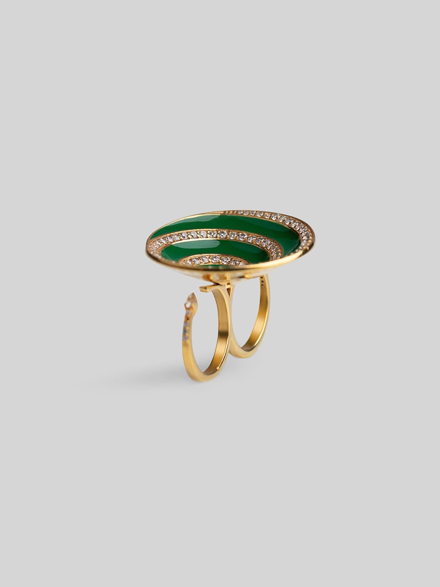  Three-quarter product shot of Orbis green enamel spiral ring in 24k gold on neutral background.