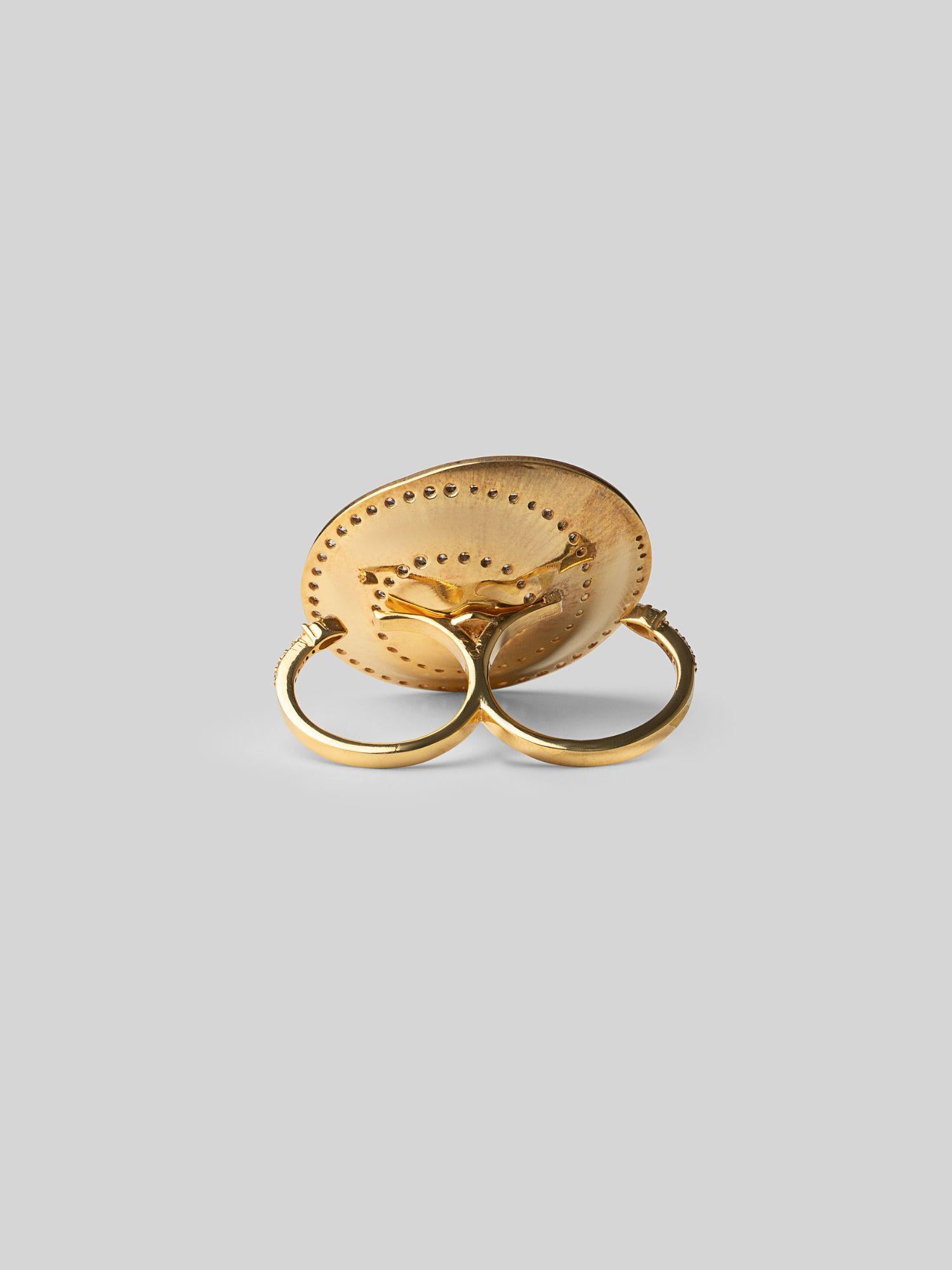Orbis sculptural cocktail ring in plain 24k gold with zircon border, face-on on neutral background.