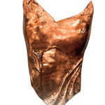 Close-up of copper corset with CZ accents worn on model, warm light