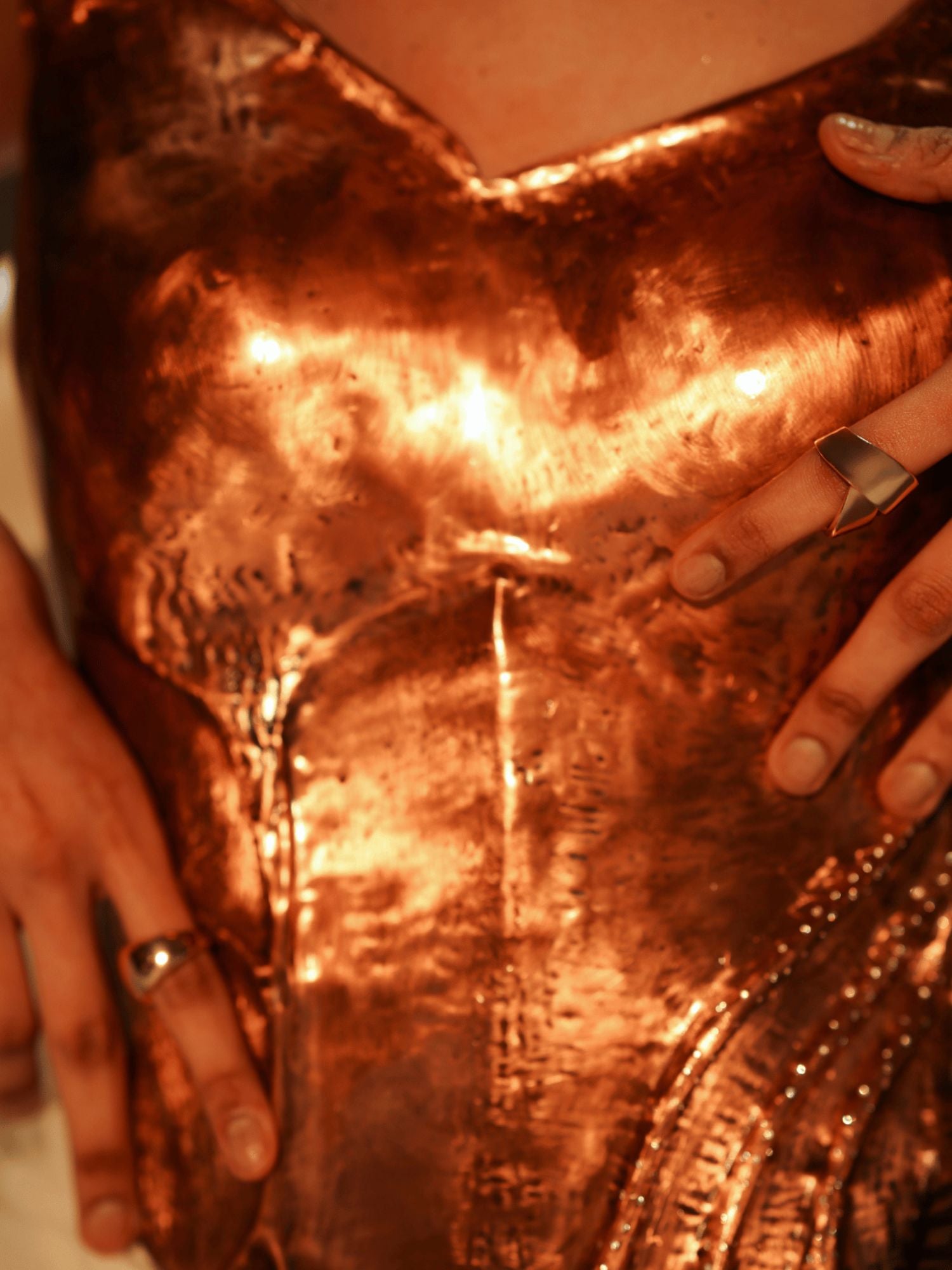 Handcrafted copper corset showing closeup and curved form