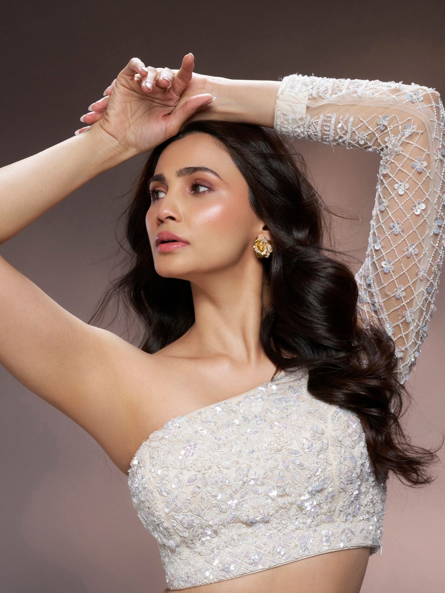 Model wearing gold geometric Rosara earrings with zircon dew drop detail, side portrait