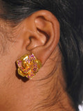 Pink CZ Rosara geometric rose statement earring worn on model in a close profile shot.