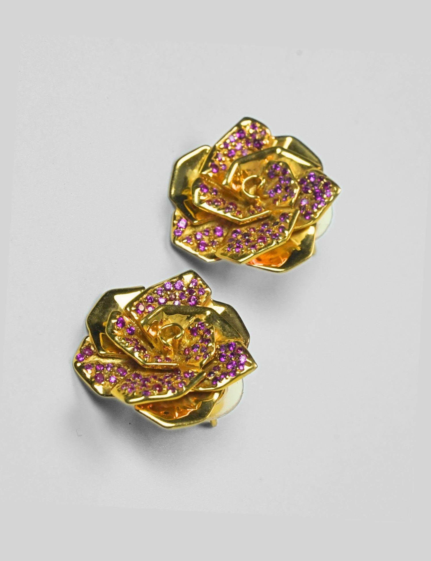 Rosara rose stud earrings with pink cubic zirconia petals in 24k gold on neutral background.