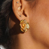Rosara rose-form statement stud earring in white CZ and gold worn on model in profile close-up.