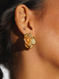 Rosara rose-form statement stud earring in white CZ and gold worn on model in profile close-up.