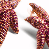 Close-up of hand-set CZ ombre starfish earrings showing stone gradation