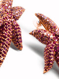 Close-up of hand-set CZ ombre starfish earrings showing stone gradation