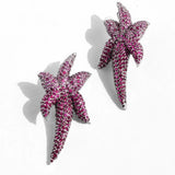 Pair of CZ ombre starfish stud earrings on white background
