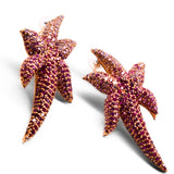 Overhead view of two starfish pendants with hand-set CZ ombre stones