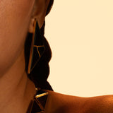 Model wearing full Tsugumi kintsugi set, earrings and necklace together in a warm editorial portrait.