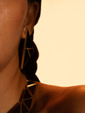Model wearing full Tsugumi kintsugi set, earrings and necklace together in a warm editorial portrait.