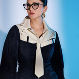 Model wearing gold Velora layered zircon earrings, front-facing portrait in blue light
