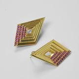 Vélora layered diamond stud earrings with pink cubic zirconia detail in 24k gold on neutral background.