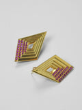 Vélora layered diamond stud earrings with pink cubic zirconia detail in 24k gold on neutral background.