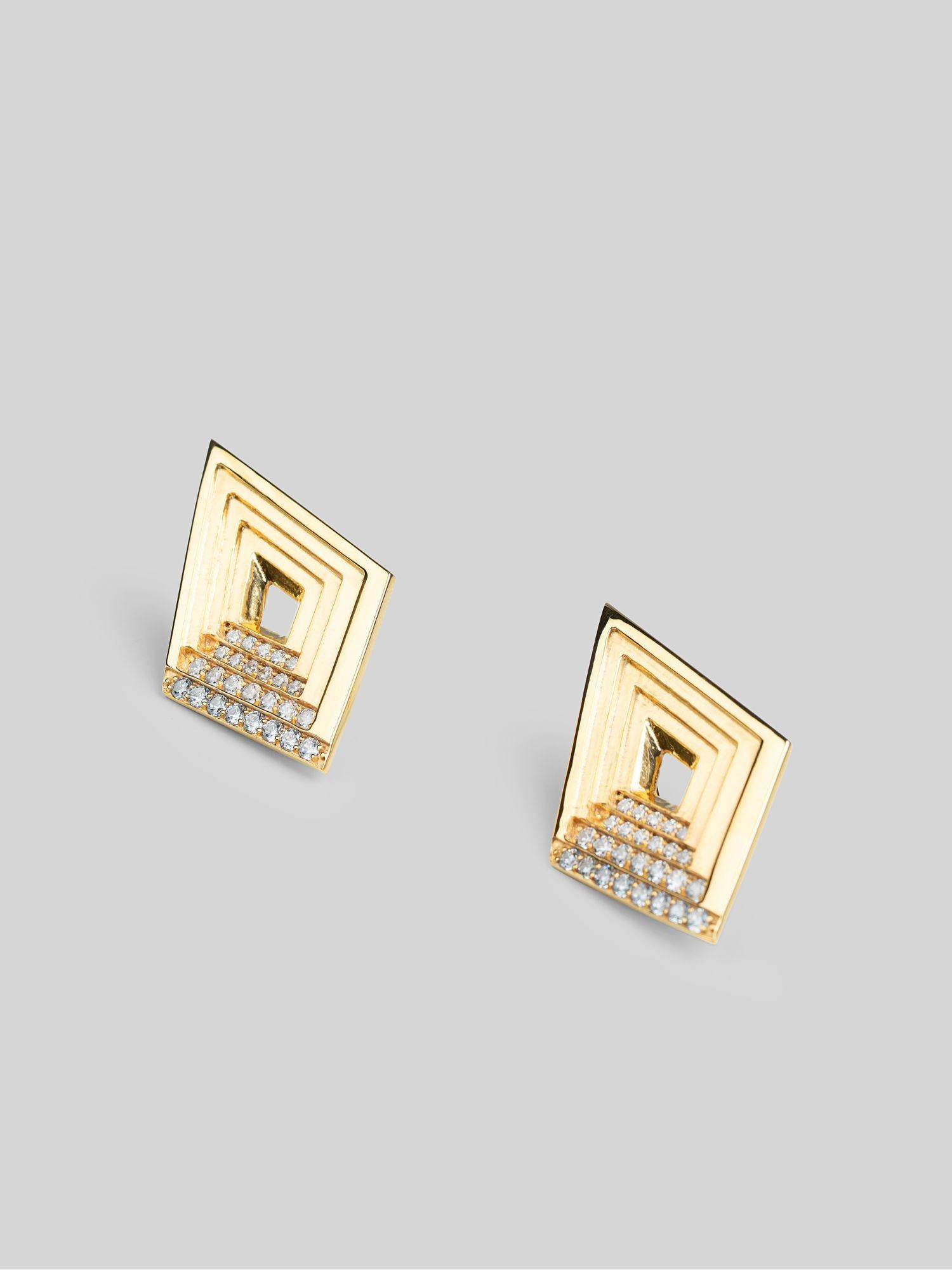 Vélora layered diamond stud earrings with white cubic zirconia in 24k gold on neutral background.