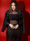 Model in black suit wearing two-tone gold and black rhodium Volupta Dual Ring