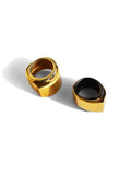 Two-tone gold and black rhodium dual cocktail rings on white background