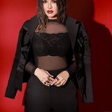 Model in suit wearing gold Volupta Ribbon cocktail ring on both hands
