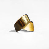 Angled product shot of gold ribbon ring showing twisted form and mixed finish